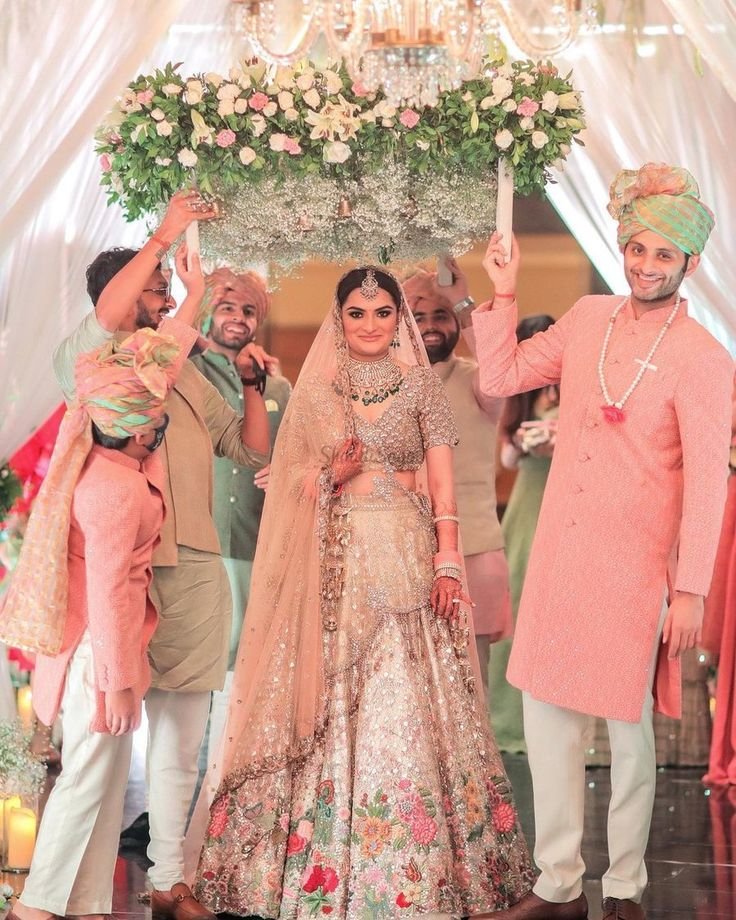Bride making a graceful entry with floral decor and soft lighting at an Indian wedding