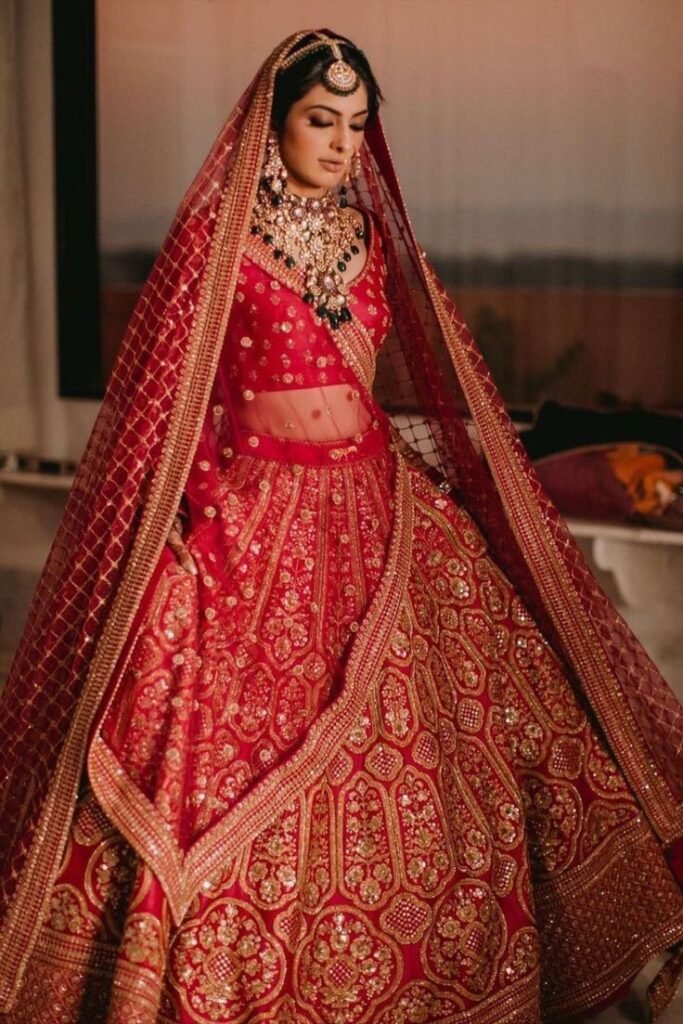 Traditional red bridal lehenga with heavy gold embroidery