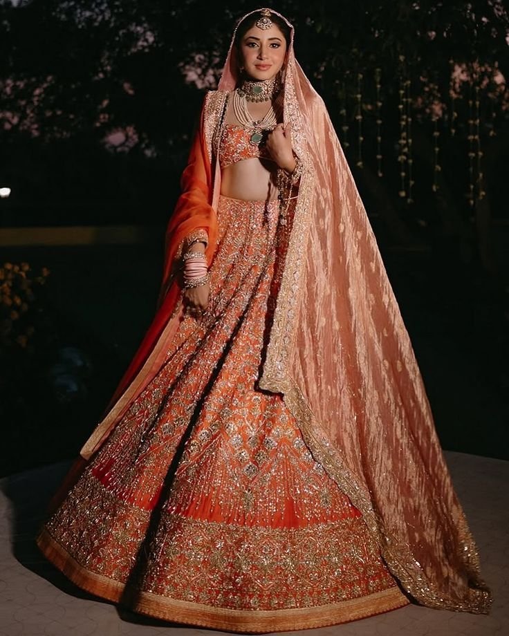 Bride wearing dupatta draped across front of lehenga