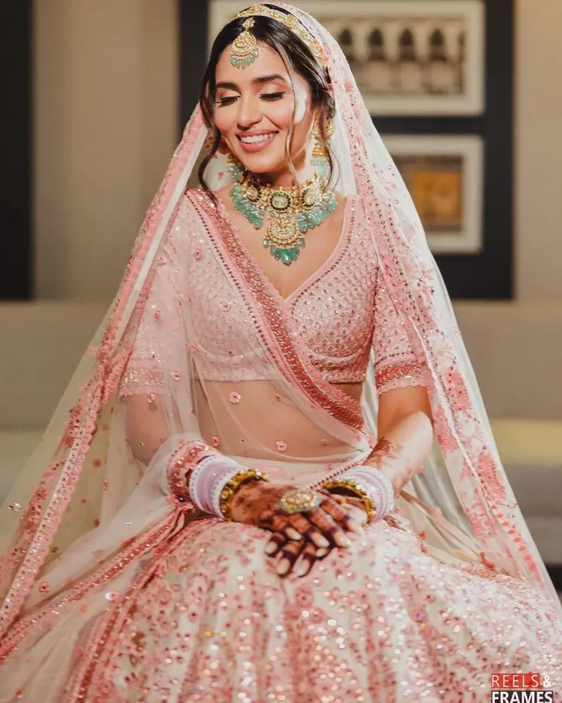 Bride wearing dupatta trailing on one side

