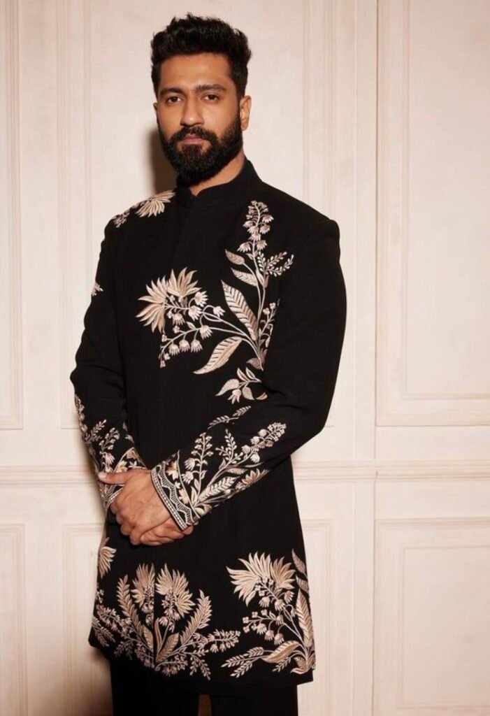 Groom wearing monochrome sherwani inspired by Bollywood