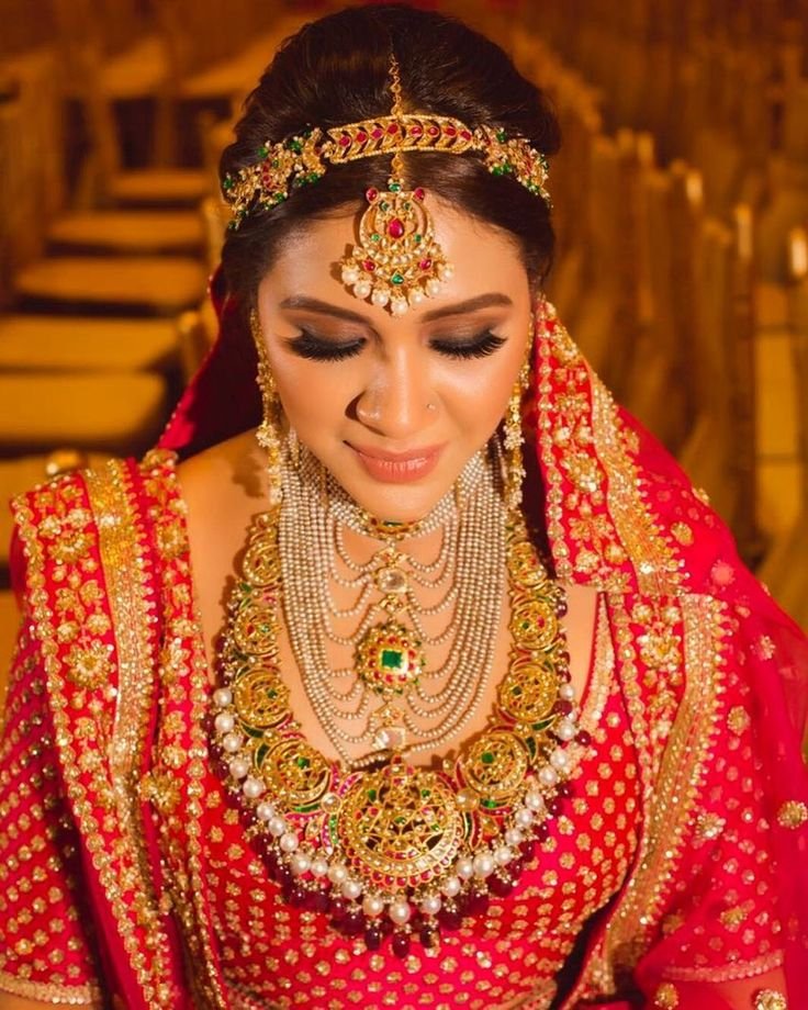 Bride wearing statement bridal jewelry

