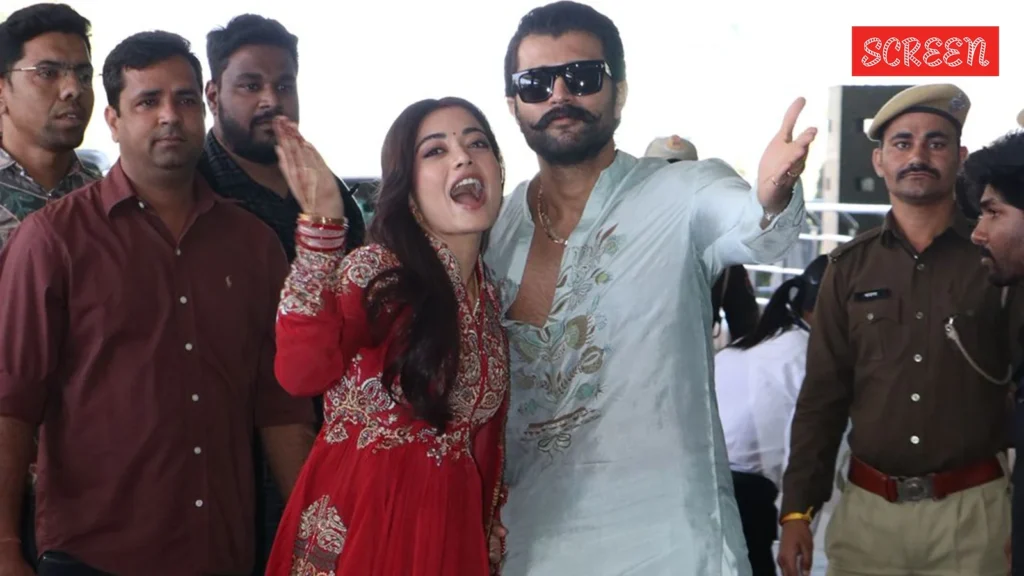Rashmika Mandanna and Vijay Deverakonda smiling together at an award function
