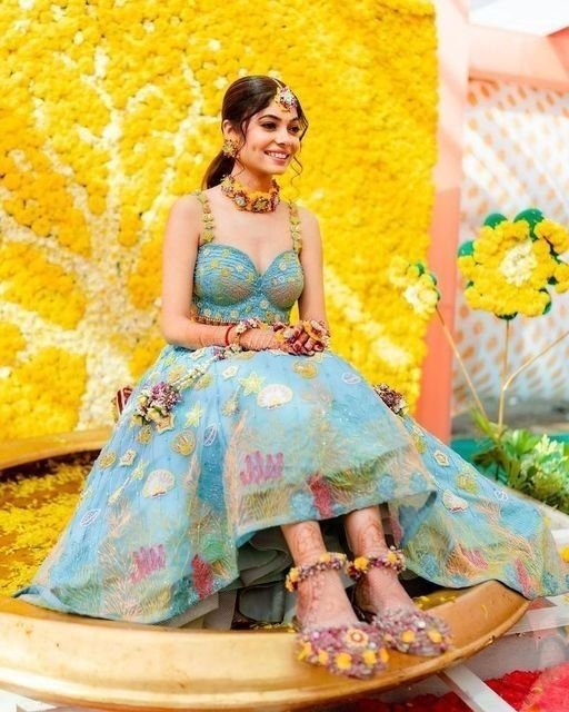  Bride wearing a yellow floral lehenga for haldi ceremony