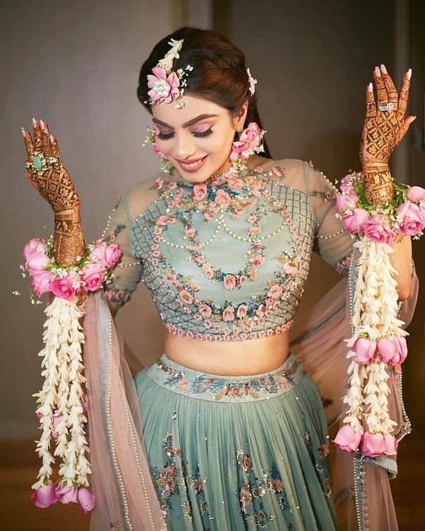 Bride wearing flower jewelry set for haldi ceremony