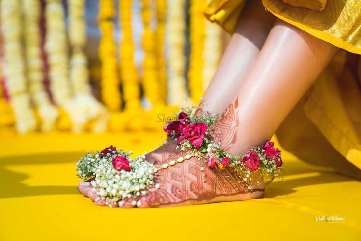 Bride wearing traditional juttis for haldi