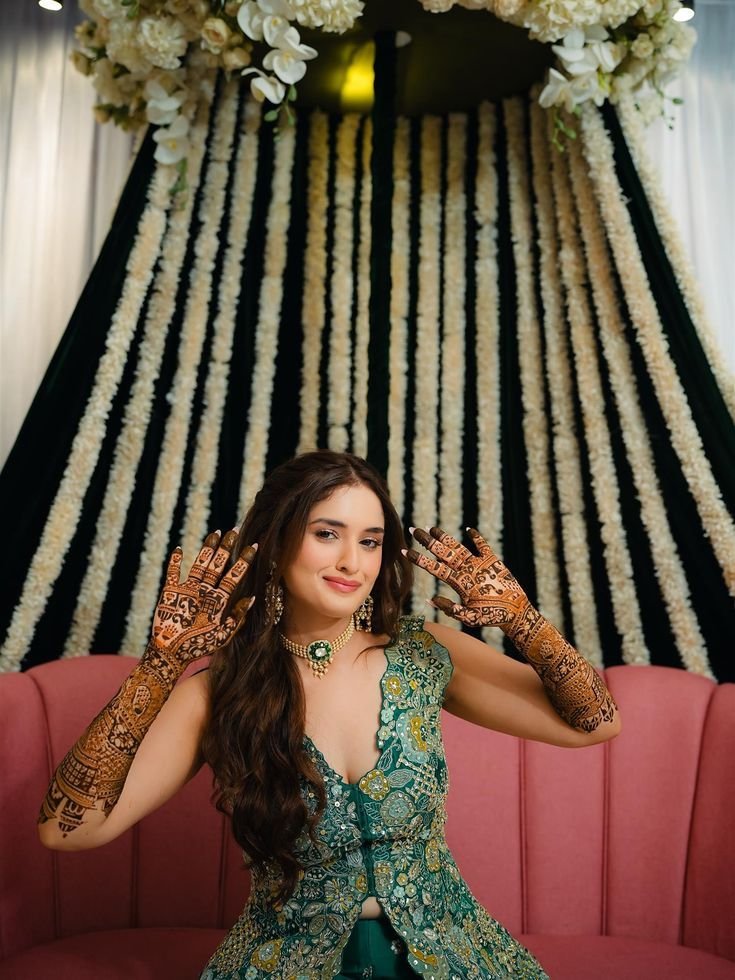 Bride wearing green lehenga for mehndi ceremony