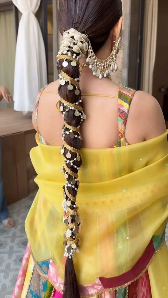 Bride with braided hairstyle for mehndi ceremony