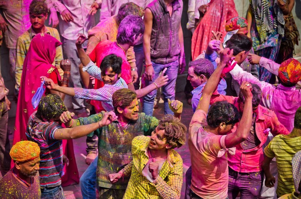Holi celebration with people dancing in colors to Bollywood music