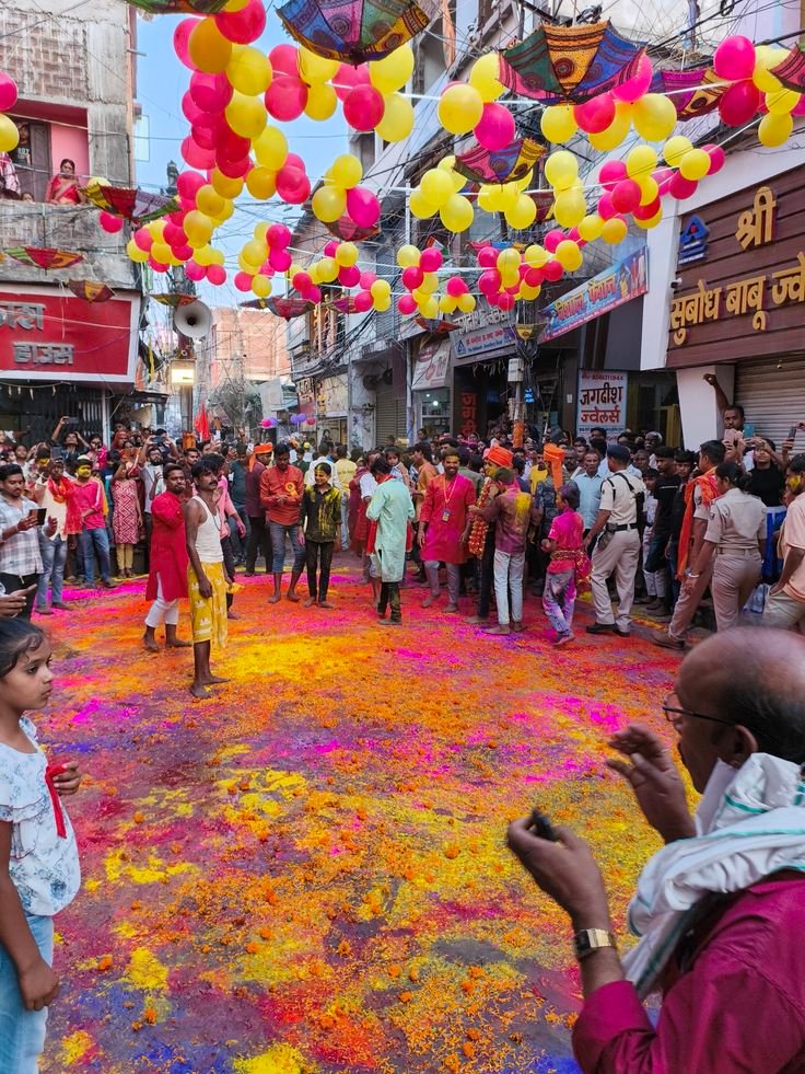 : Holi party decoration with colorful balloons and powder setup

