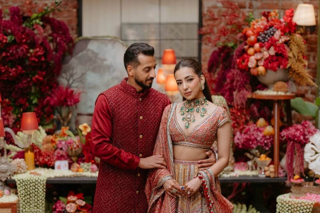 Indian bride and groom wearing complementary wedding colors.