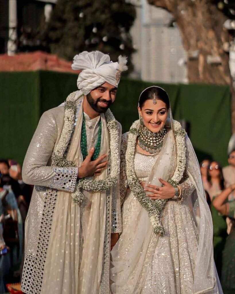 Groom accessories matching bridal lehenga.